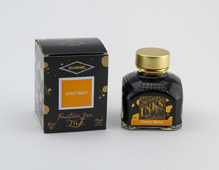 Diamine 80 ml Tintenglas Honey Burst neben der dazugehörigen Verpackung.